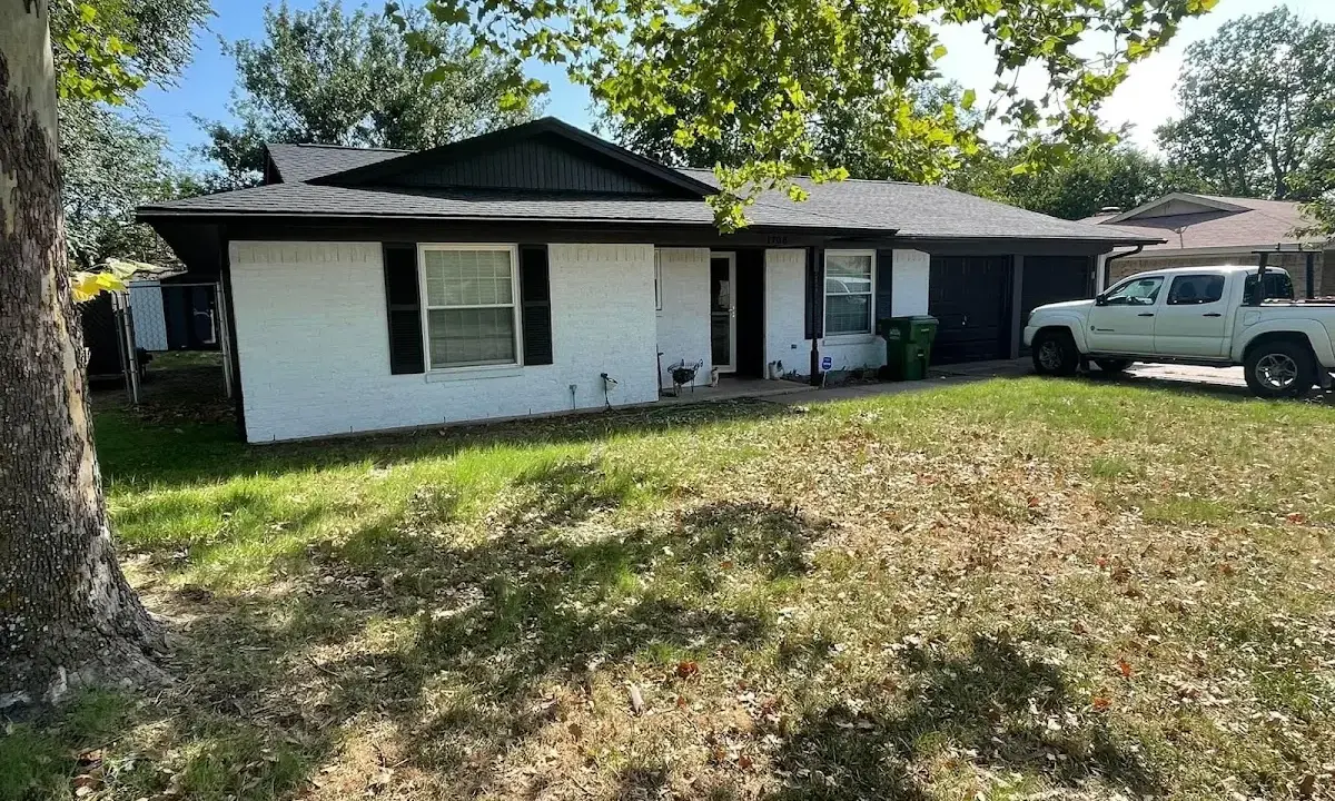 Professional roofing crew working on a residential roof in Ward